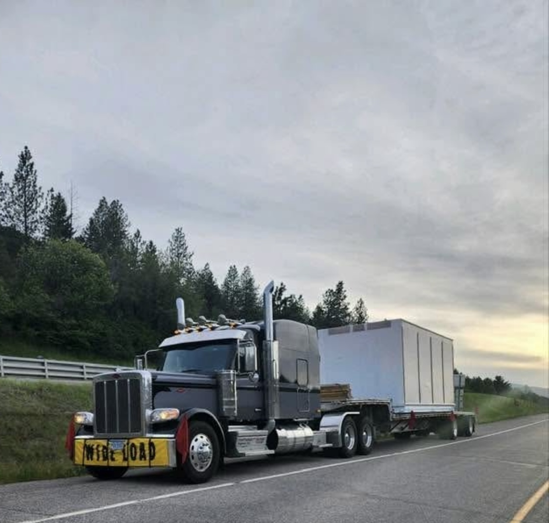 Flatbed semi-truck on the highway at sunset